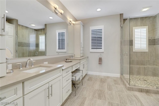 bathroom featuring vanity and a shower with shower door