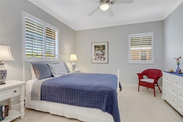 carpeted bedroom with crown molding and ceiling fan