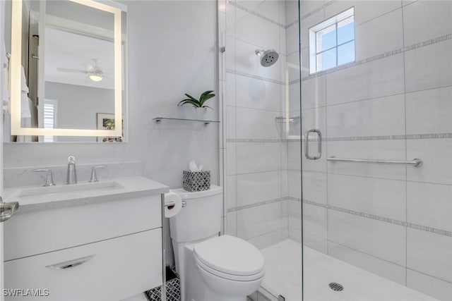 bathroom featuring vanity, toilet, and a shower with shower door