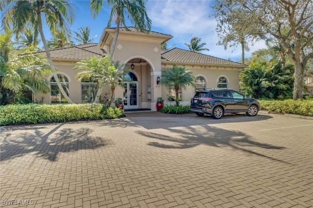 mediterranean / spanish house featuring french doors