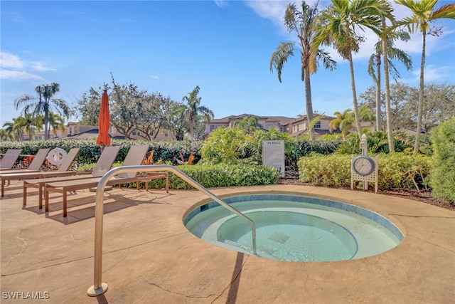 view of pool with a hot tub