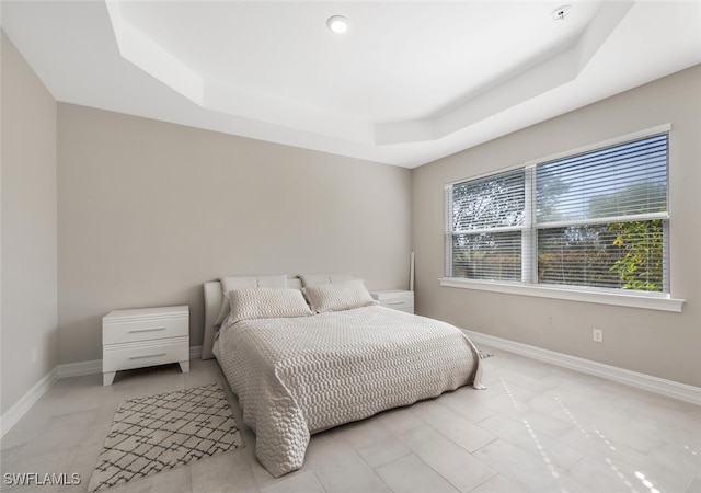 bedroom with a tray ceiling