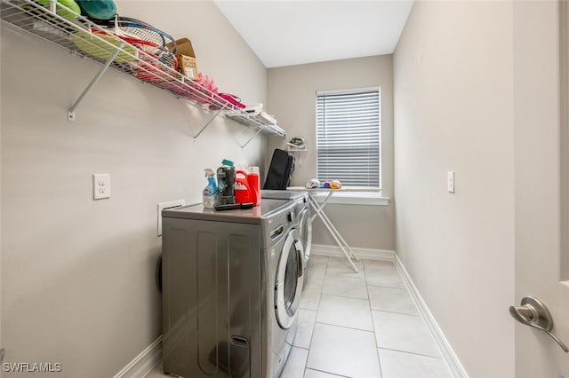 washroom with washer and clothes dryer and light tile patterned floors