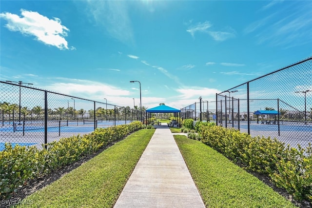 view of property's community with tennis court