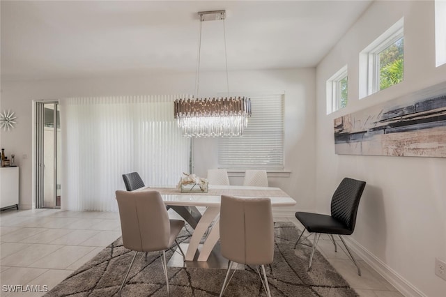 dining room with light tile patterned flooring and a chandelier