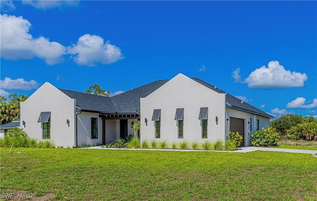 view of front of property featuring a garage and a front lawn