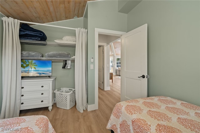 bedroom with wooden ceiling and light hardwood / wood-style floors