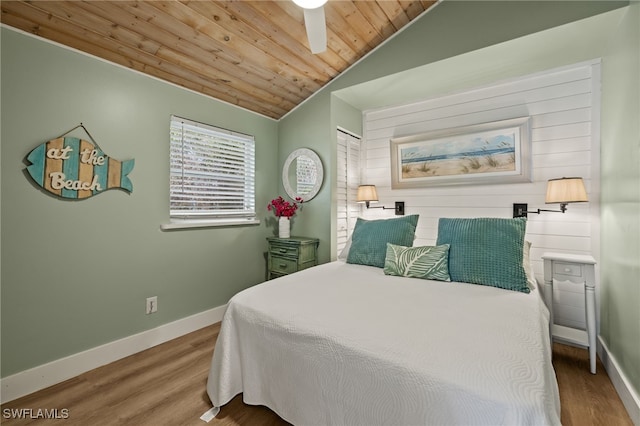 bedroom with hardwood / wood-style flooring, lofted ceiling, and wood ceiling