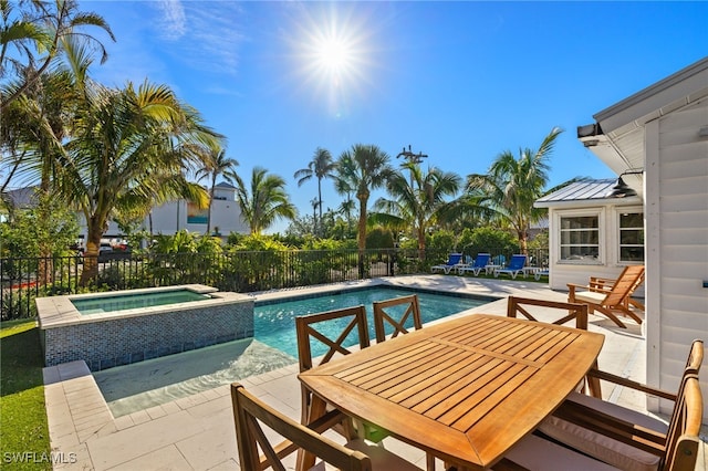 view of pool with an in ground hot tub and a patio area