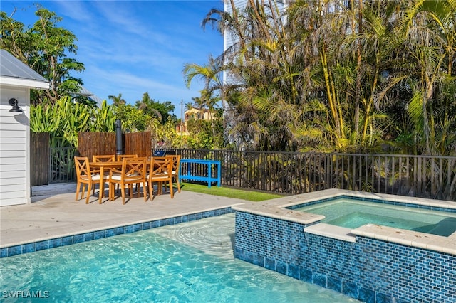 view of pool featuring an in ground hot tub and a patio area