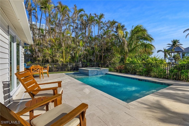 view of swimming pool featuring a patio area and an in ground hot tub