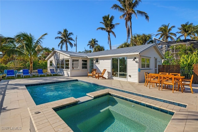 view of swimming pool with an in ground hot tub and a patio area