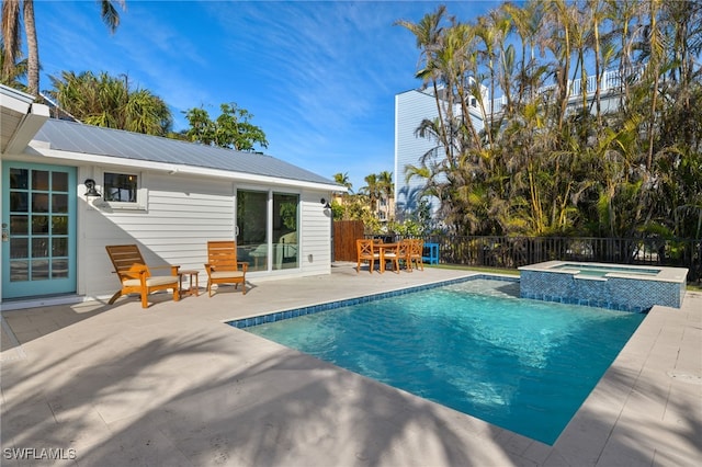 view of swimming pool featuring a patio and an in ground hot tub