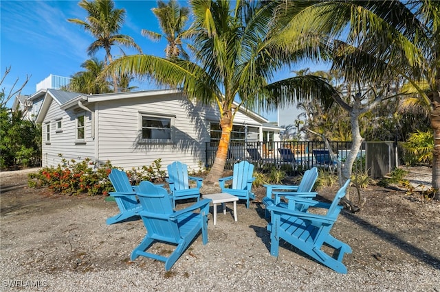 exterior space with a wooden deck and a fire pit