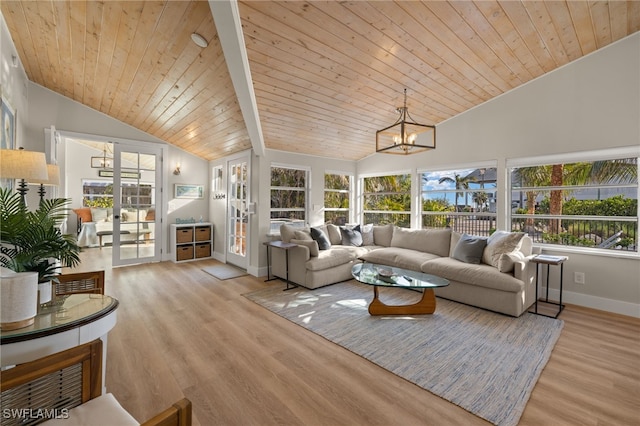 living room featuring lofted ceiling, light hardwood / wood-style flooring, wooden ceiling, and french doors