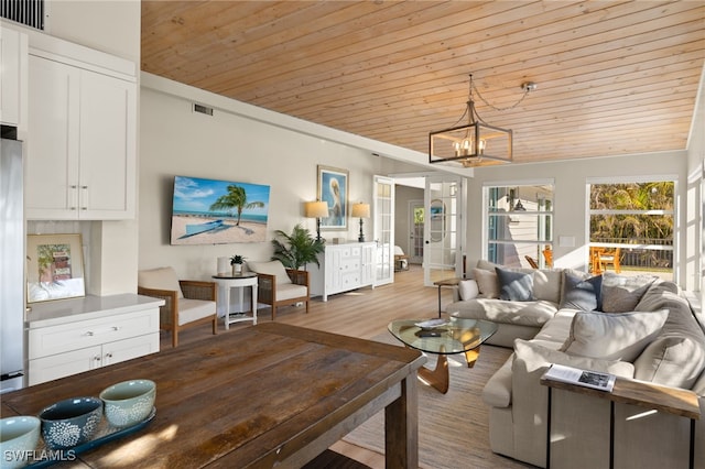 living room with lofted ceiling, a chandelier, light hardwood / wood-style floors, and wooden ceiling