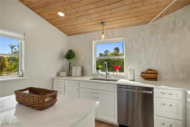 kitchen with lofted ceiling, sink, white cabinetry, dishwasher, and pendant lighting