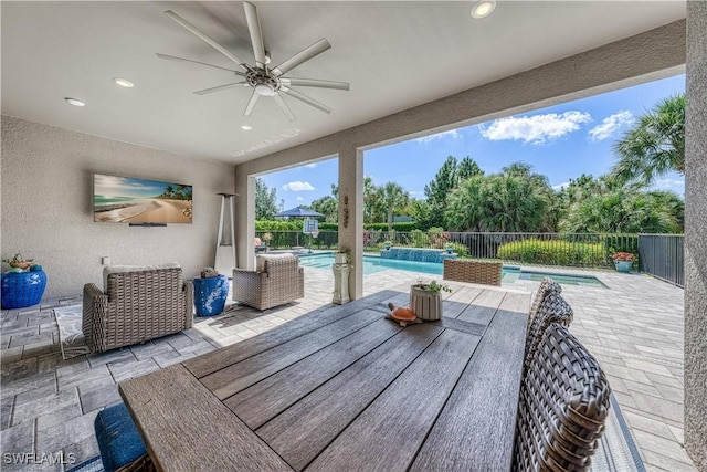 view of patio / terrace featuring a fenced in pool and ceiling fan