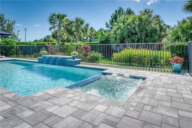 view of swimming pool featuring a patio, fence, and a pool with connected hot tub