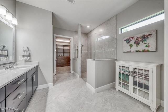 bathroom featuring vanity and tiled shower