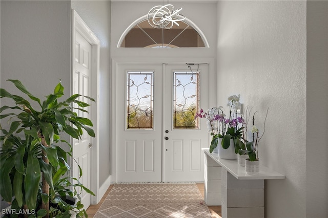 entryway with an inviting chandelier and french doors