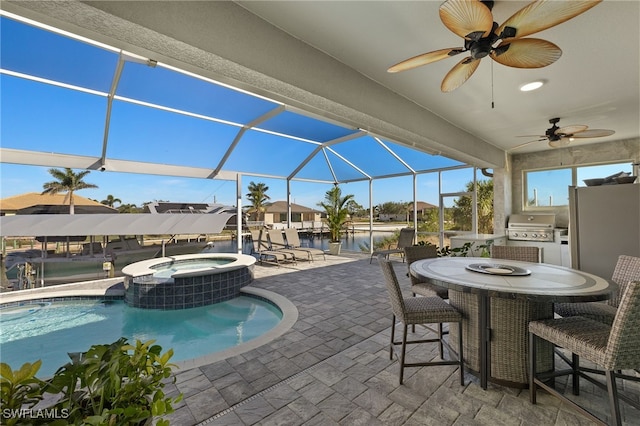 view of swimming pool featuring grilling area, a lanai, an in ground hot tub, exterior kitchen, and a patio