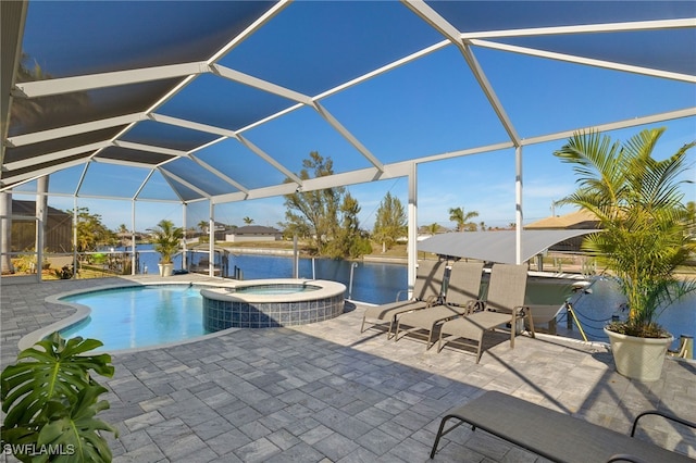 view of swimming pool featuring an in ground hot tub, a water view, a patio area, and glass enclosure