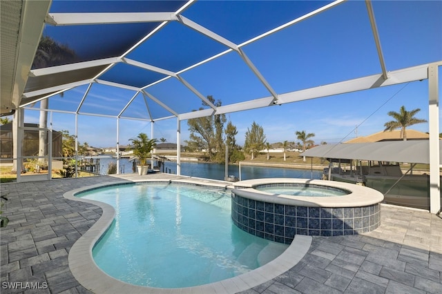 view of pool featuring a water view, glass enclosure, a pool with connected hot tub, and a patio area