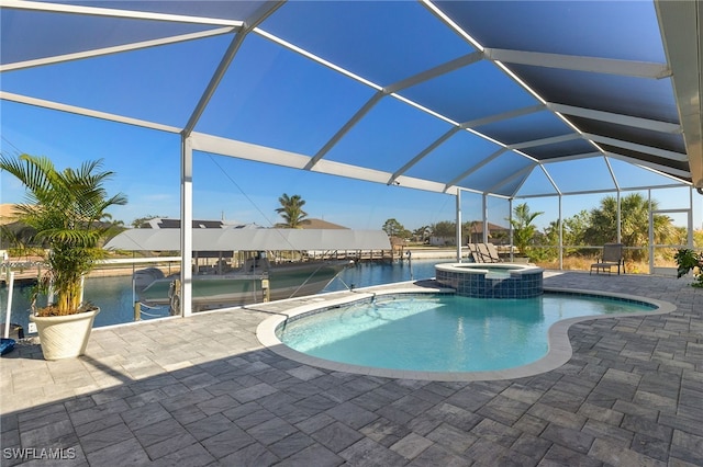 view of pool featuring a patio area, an in ground hot tub, and glass enclosure