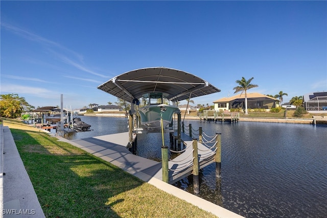 dock area with a water view and a yard