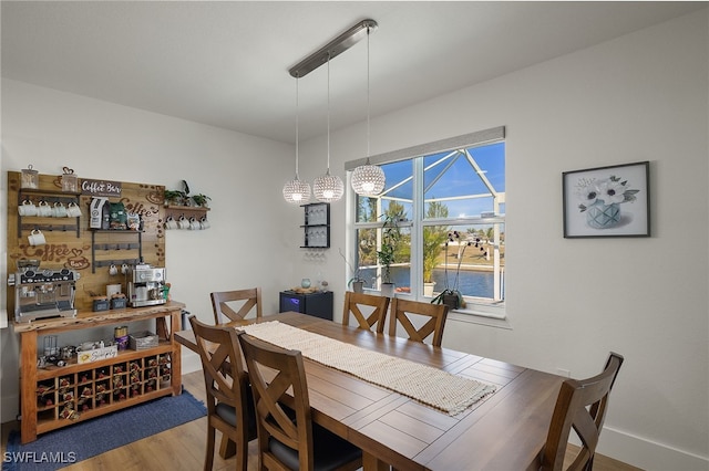 dining space with wood-type flooring