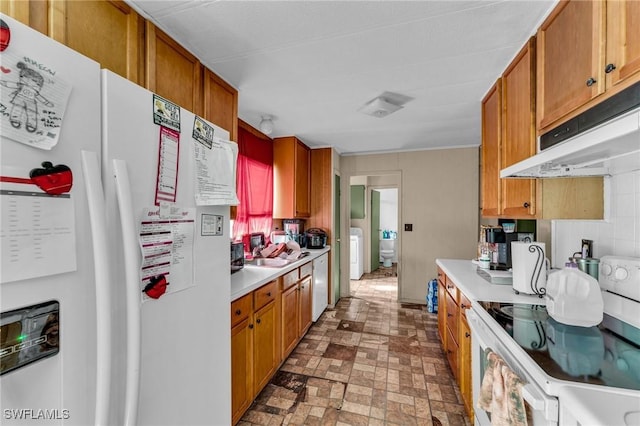 kitchen with white appliances, washer / clothes dryer, and sink