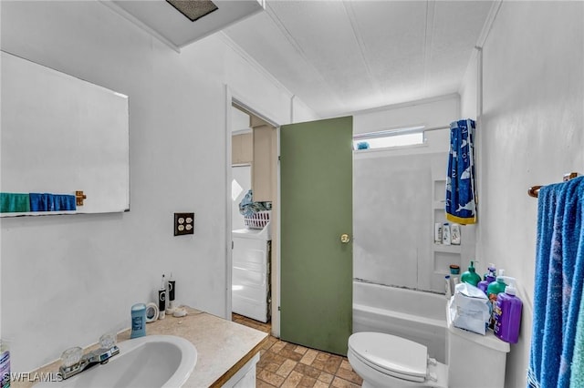 full bathroom featuring vanity, toilet, washer / dryer, and bathing tub / shower combination