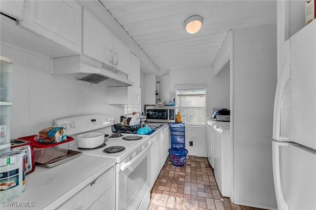 kitchen featuring independent washer and dryer, white cabinets, and white appliances