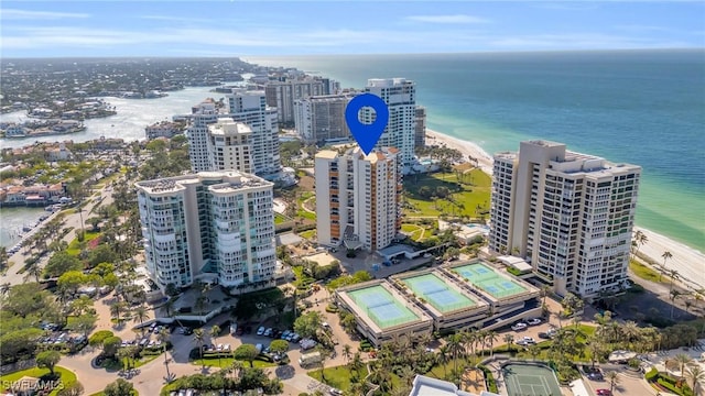 bird's eye view featuring a water view and a beach view