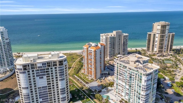 birds eye view of property featuring a beach view and a water view