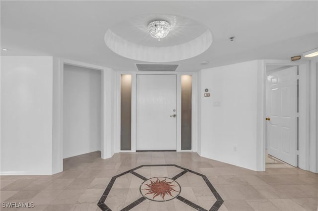 entrance foyer with a raised ceiling