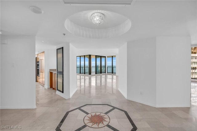 hallway featuring a tray ceiling