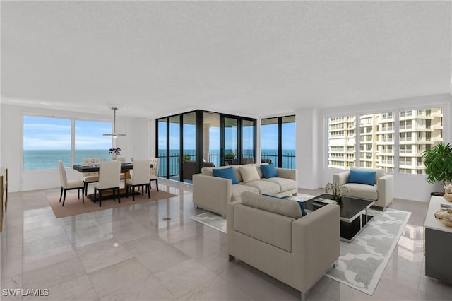 living room with a water view and a textured ceiling