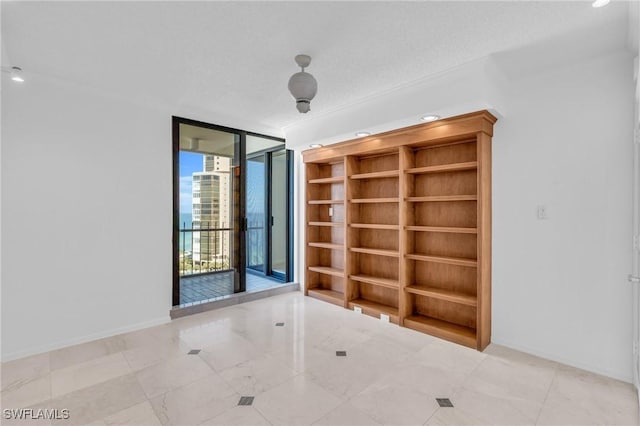 spare room featuring expansive windows and a textured ceiling