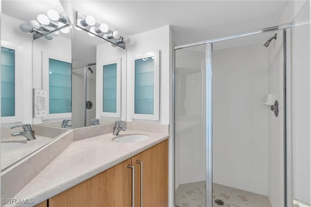 bathroom with vanity and a shower with door