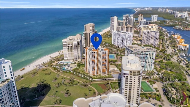 birds eye view of property with a water view and a view of the beach