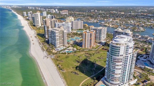 drone / aerial view featuring a water view and a view of the beach