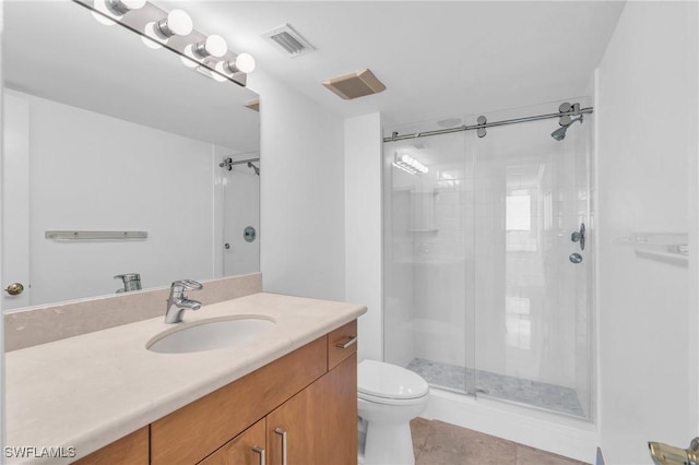 bathroom with tile patterned floors, vanity, toilet, and an enclosed shower