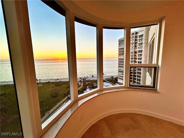 unfurnished sunroom featuring a water view