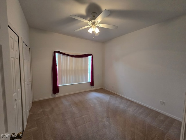 unfurnished bedroom featuring carpet floors and ceiling fan