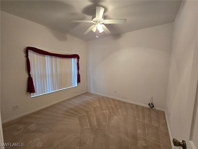 spare room with carpet flooring and ceiling fan