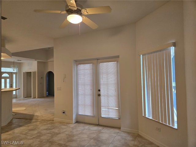 interior space with light tile patterned flooring and ceiling fan