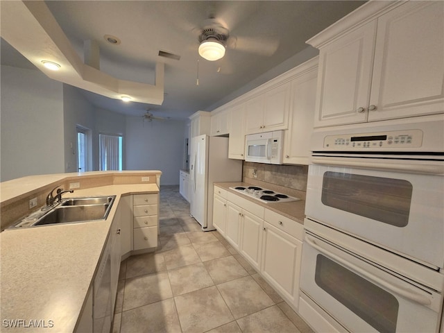 kitchen with white cabinetry, white appliances, sink, and tasteful backsplash