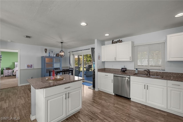 kitchen with sink, white cabinetry, decorative light fixtures, stainless steel dishwasher, and dark hardwood / wood-style floors